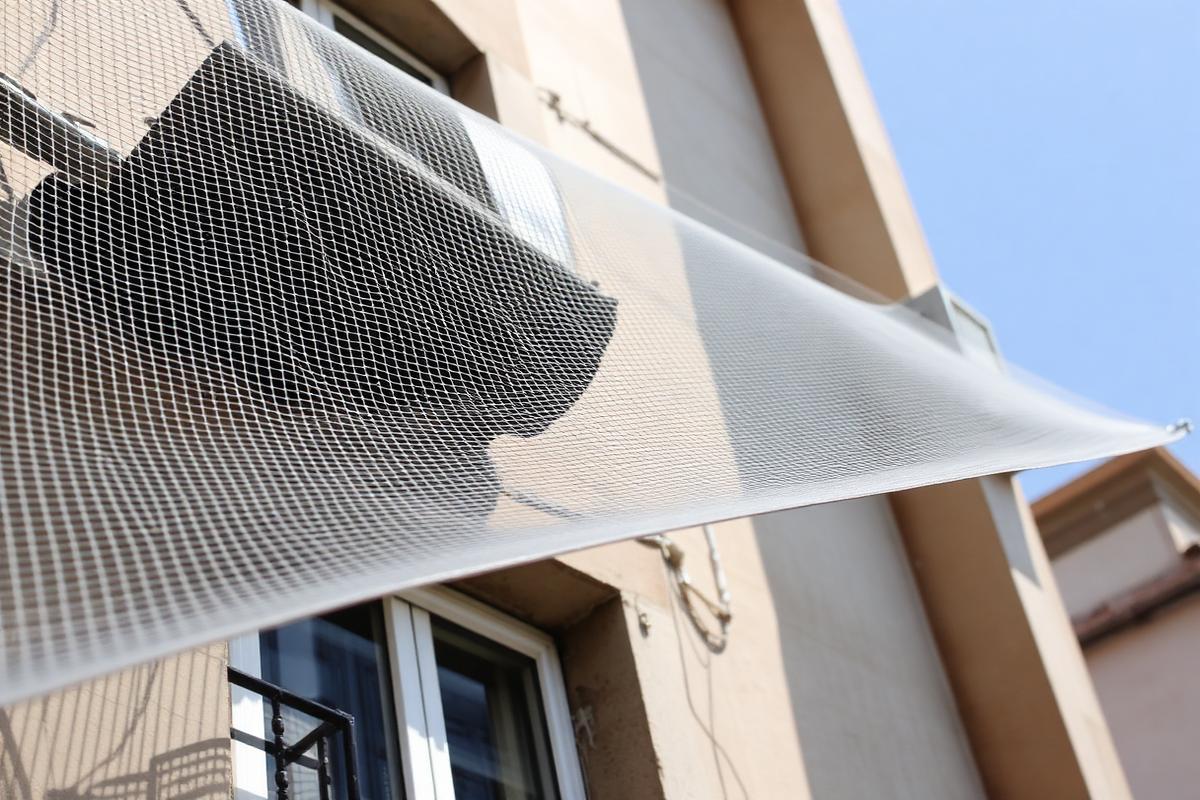 Bird netting fixed over openings and ducts on a building
